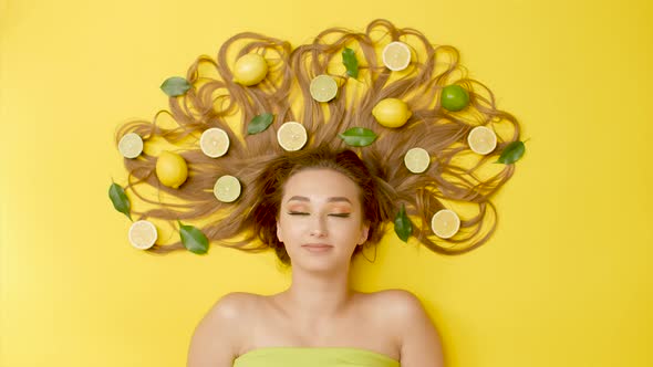 girl lying with citrus fruits on long hair, woman thinking, thoughts in head, concept choice