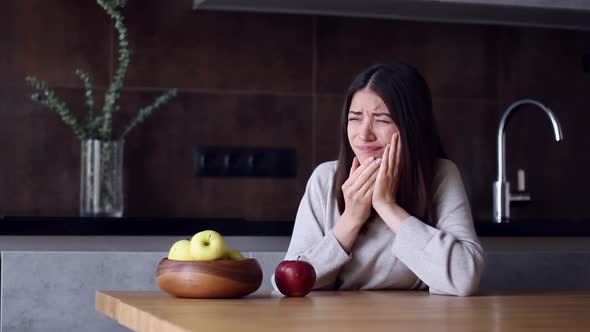 Woman With Toothache Eating Red Apple