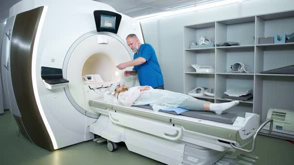 Magnetic Resonance Imaging in the Modern Hospital Adult Man Doctor Performs a Magnetic Tomographic