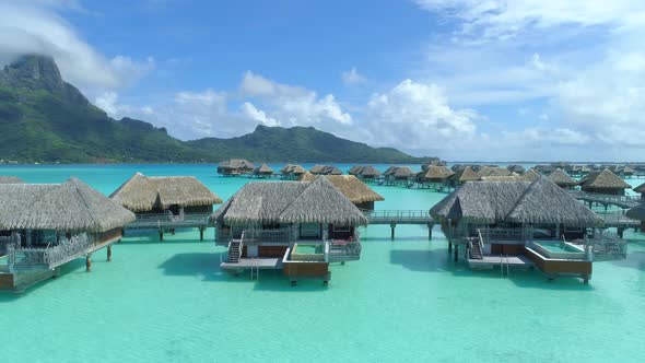 Aerial drone view of a luxury resort and overwater bungalows in Bora Bora tropical island