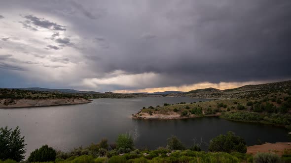 Time lapse of storm blowing over lake as dark clouds move through the sky