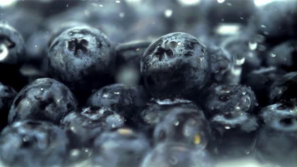 Super Slow Motion Drops of Water Fall on Blueberries