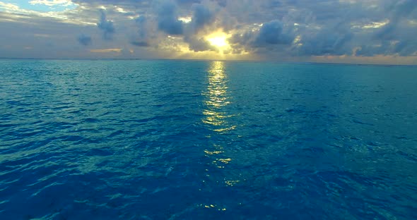 Beautiful birds eye travel shot of a white paradise beach and blue ocean background in vibrant 