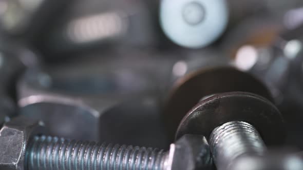 Slider Shot Video of Chrome Bolts and Nuts in a Chaotic Order Industrial Background