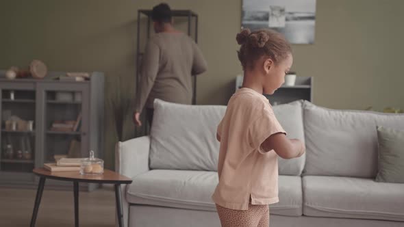 Little Girl Exercising at Home