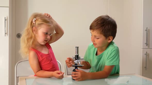 Beautiful Children Are Amazed By the Image in a Microscope Lens