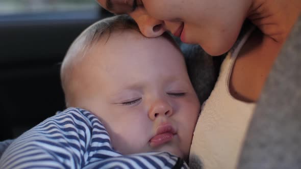 Sleeping Baby with Mother in a Car