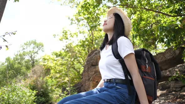 Beautiful asian woman backpacking sitting relaxation with nature