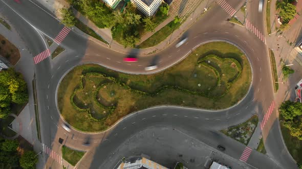 4k aerial view time lapse of road with circular cars in small european city