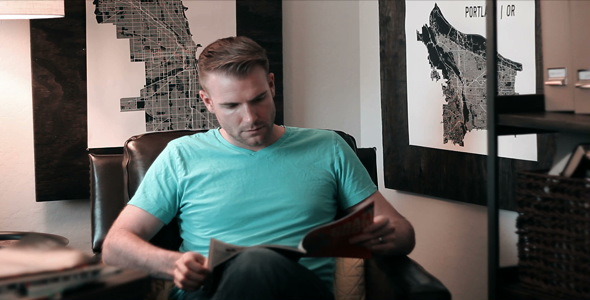 Man Casually Reading Magazine in Leather Chair