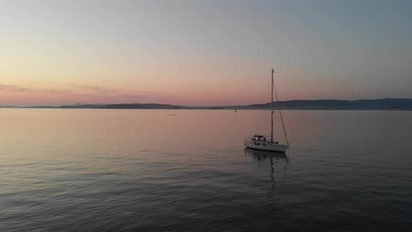 The romantic colors of sundown at Bueu beach, Galicia, Spain.  A bird gliding by during the aerial c