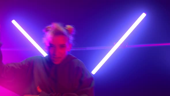 Blonde Artist Dancing Hiphop at Neon Lights Close Up