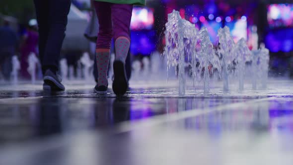 People Walking by Water Jets