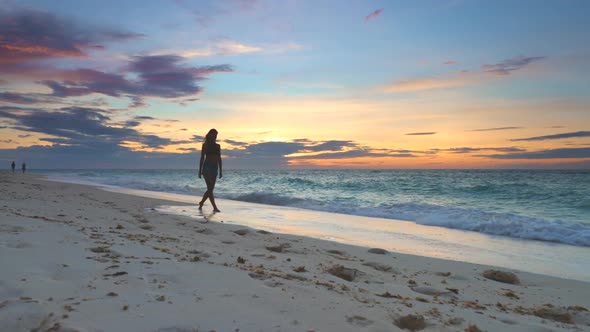 Girl with Model Walking Strolling Along Coastline