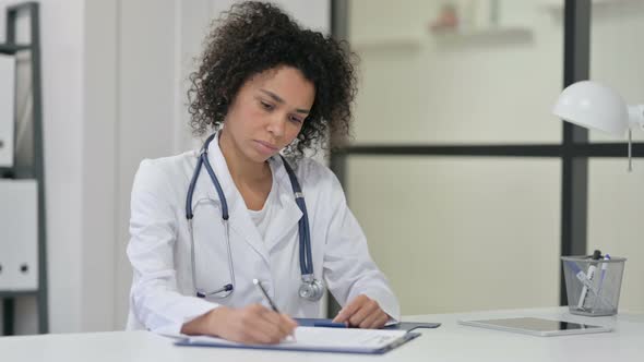 Female African Doctor Writing Paper