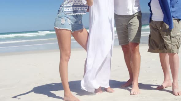 Happy family taking selfie from mobile phone at beach