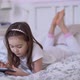 Girl in Pajama Playing Videogame on Tablet - VideoHive Item for Sale