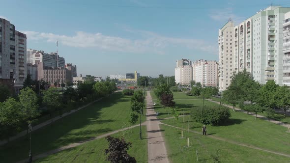 Flying on a Drone Over a Park in the City