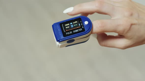 Closeup on a Finger in a Pulse Oximeter