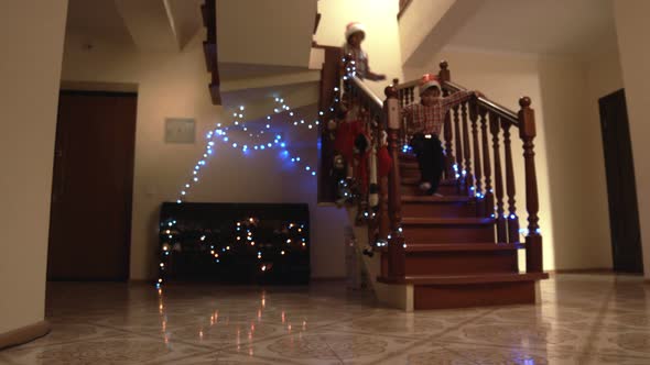 Christmas Kids Run Down Staircase.