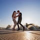 Playful dancing couple. Couple dancing on the embankment of the river - VideoHive Item for Sale