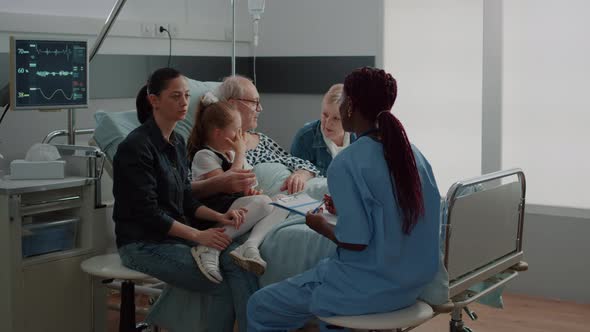 Medical Assistant Talking About Diagnosis with Woman in Visit