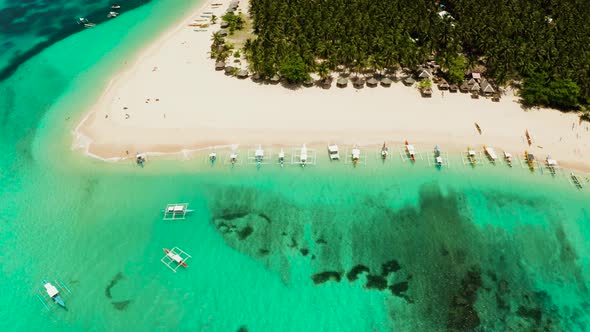 Tropical Daco Island with a Sandy Beach and Tourists