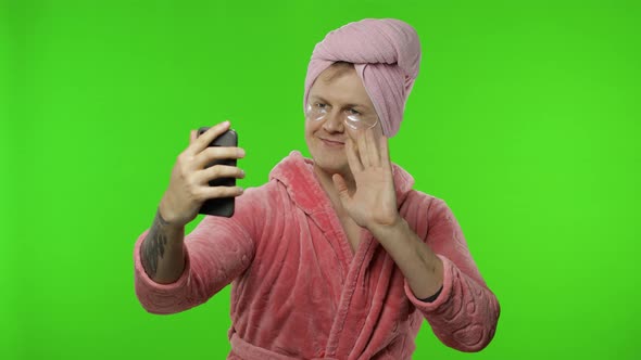 Portrait of Young Man in Bathrobe Using Mobile Phone for Video Call