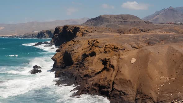 View of Cofete Beach in Fuerteventura Spain with the Sea and Mountains at Sunset Big Waves