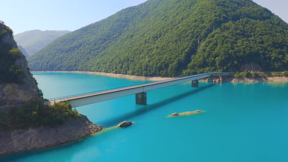 Bright summer view of Pivsko lake with bridge.