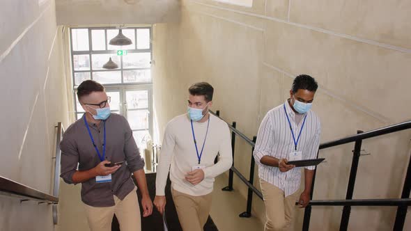 Businessmen in Masks with Name Tags Going Upstairs