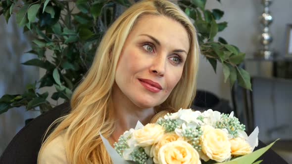 The Woman Holding a Bouquet of Flowers