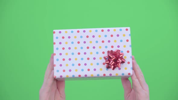 Man's Hands Are Giving a Christmas Present or a Birthday Present