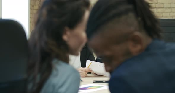 Caucasian Woman and African American Man Whispering at Business Meeting. Serious Nervous CEO