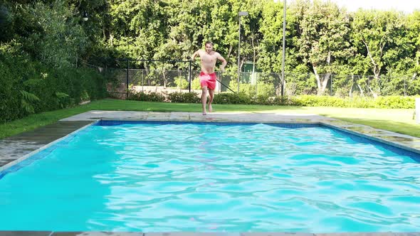 Man jumping into swimming pool