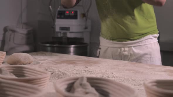 Slow Motion of Hands of Baker Chef Applying Flour on Dough