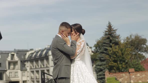 Lovely Newlyweds Caucasian Bride Embracing Groom in Park Making Kiss Wedding Couple Family Hugging