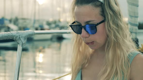 Woman Smiles While Working with Laptop on Yacht