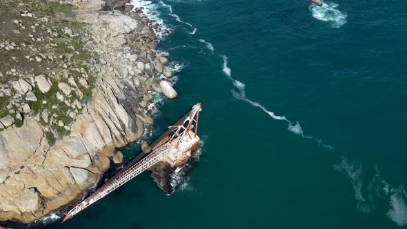 Aerial view of shipwreck crane barge is off the coast of Sandy Bay.