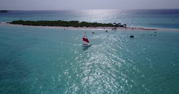 Tropical aerial tourism shot of a paradise sunny white sand beach and blue sea background in high re