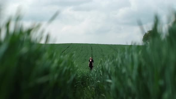 Image Of Girl In Black Dress In Field.