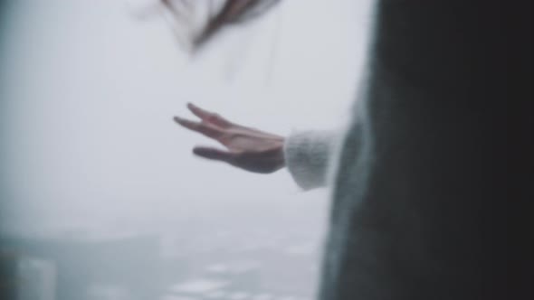 Hand of a woman touching the snow