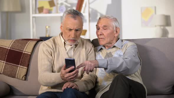 Senior Male Showing New Smartphone Elderly Friend, Using Modern Technology
