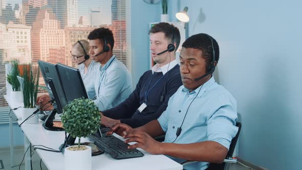 Black Customer Support Agent Working in Busy Call Center By Talking To the International Client