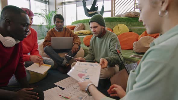 Team of Start-Up Workers Discussing Documents