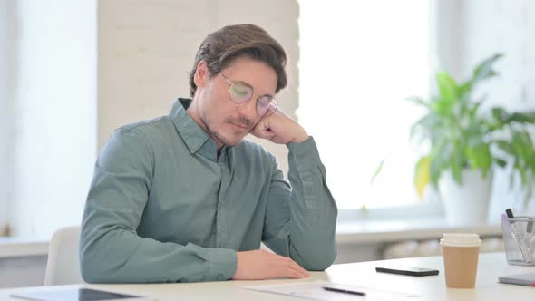 Middle Aged Man Taking Nap in Office 