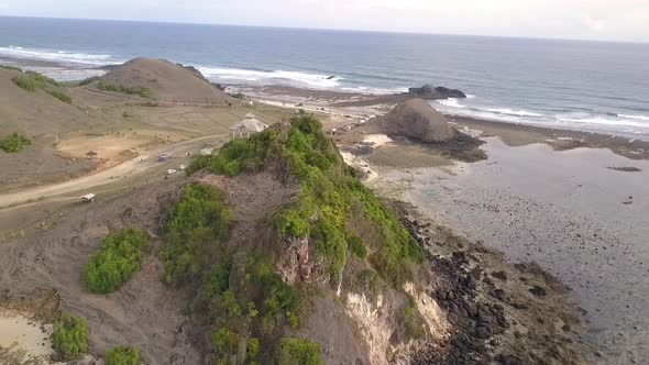 Pantai Seger Lonely people on the top of a hillPerfect aerial view flight sinking down drone footag