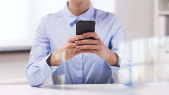 Businesswoman with Smartphone Working at Office