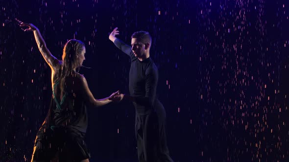 Passionate Bachata Dance Among the Raindrops Performed By a Young Sensual Couple of Dancers