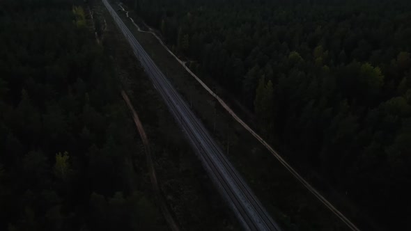 Drone Point of View Over Railroad Revealing City and Lake